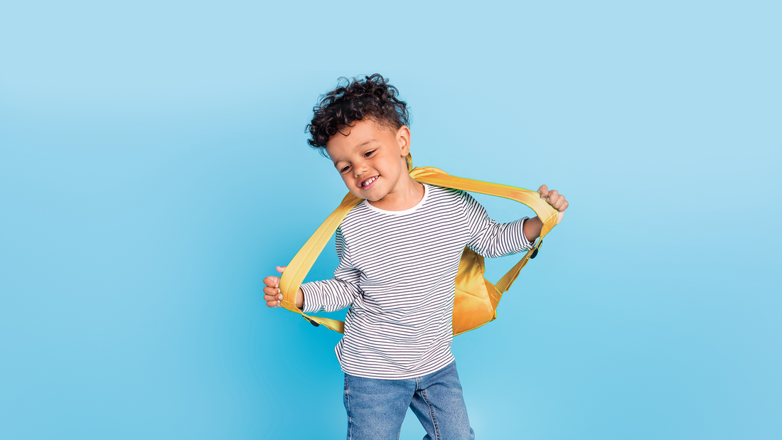 a child with a backpack ready to go to school